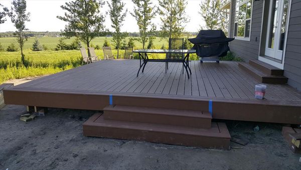 Trex Select Saddle decking and matching border/fascia on a new construction home.  No railing on this one since it is less than 30&amp;amp;quot; from grade