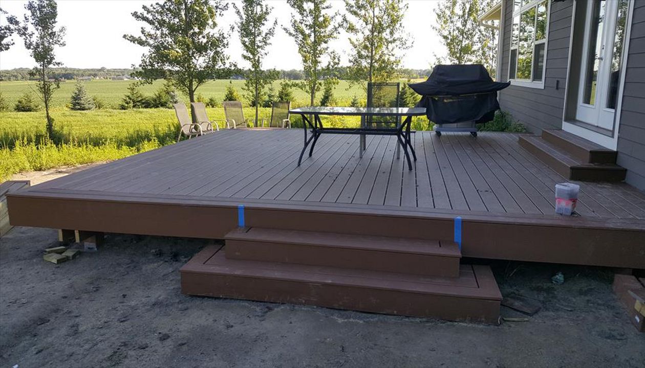 Trex Select Saddle decking and matching border/fascia on a new construction home.  No railing on this one since it is less than 30&amp;amp;quot; from grade