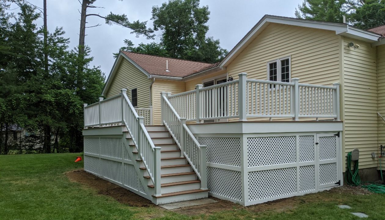 Trex Transcend "Tiki Torch" decking with white Transcend railings.
