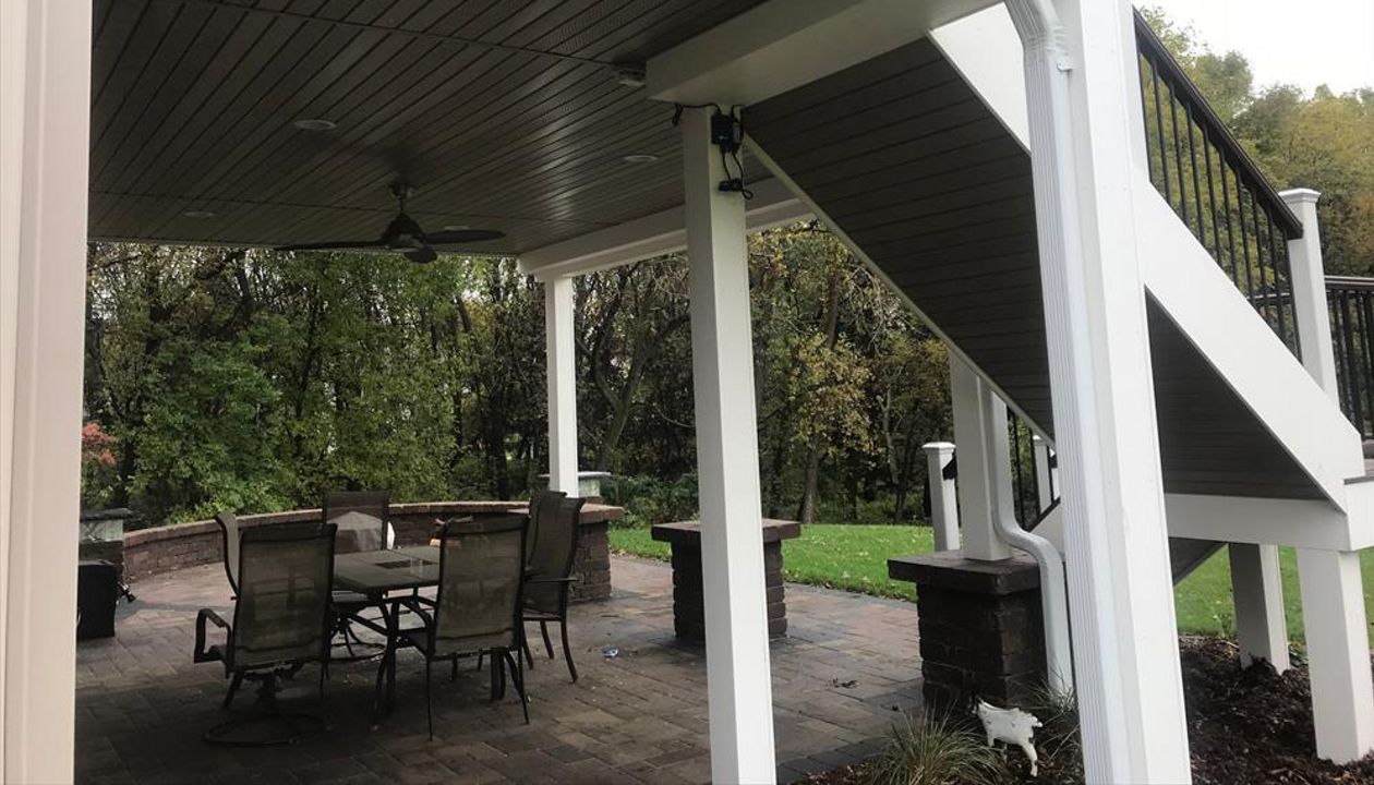 Trex Transcend Composite Deck & Rail with Finished Outdoor Living Space Underneath Thanks to Trex Rain Escapes Drainage System in Rochester, MN