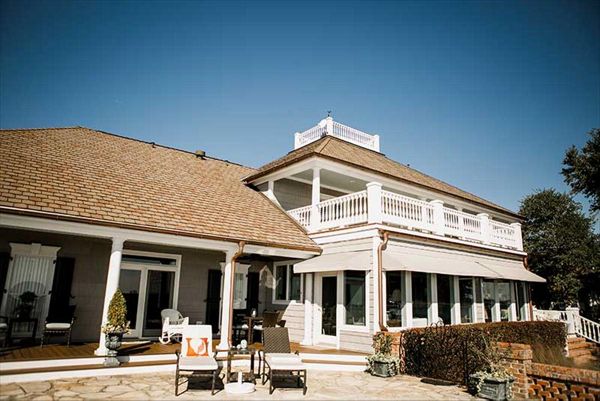 This living space extends the entire back of this custom home & showcases Trex Transcend Spiced Rum decking.