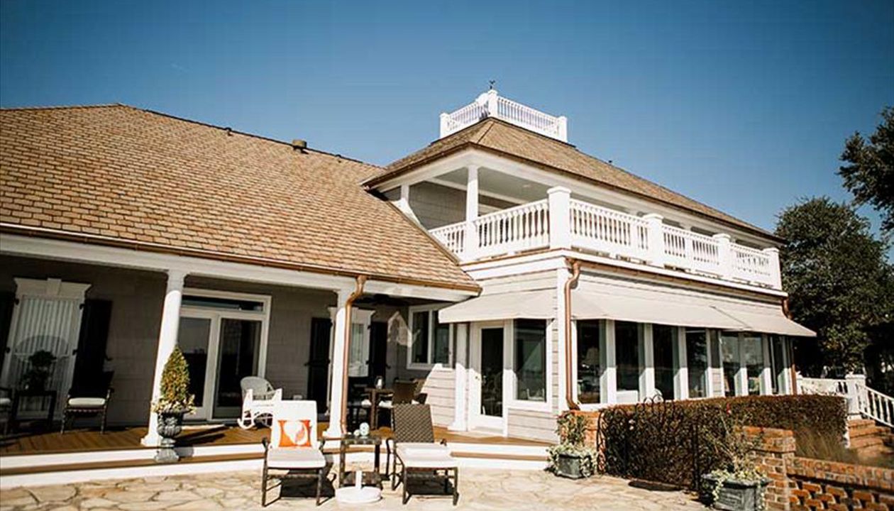 This living space extends the entire back of this custom home & showcases Trex Transcend Spiced Rum decking.