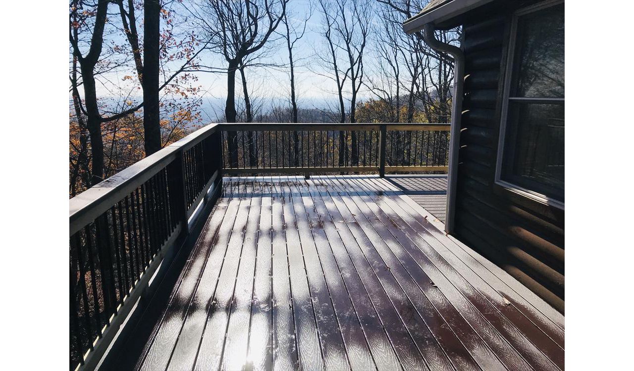 This Trex Select Madeira deck wraps around this home with a fantastic view of the mountains