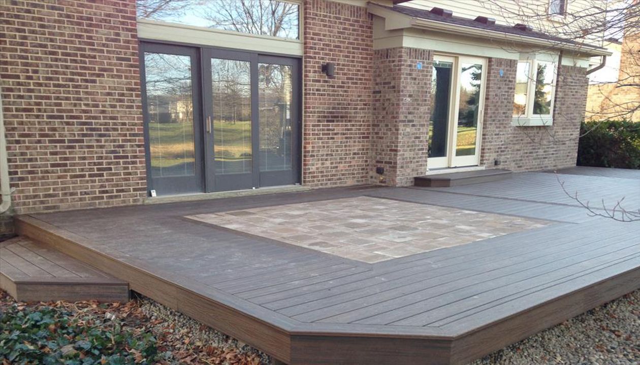 Check out this Trex deck Images Landscaping and Construction built in Northville, MI out of Trex Transcend Spiced Rum decking and fascia; featuring a brick paver inlay.