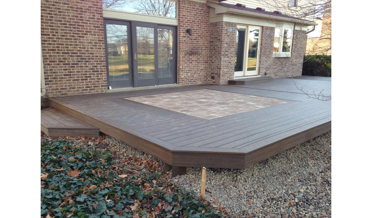 Check out this Trex deck Images Landscaping and Construction built in Northville, MI out of Trex Transcend Spiced Rum decking and fascia; featuring a brick paver inlay.