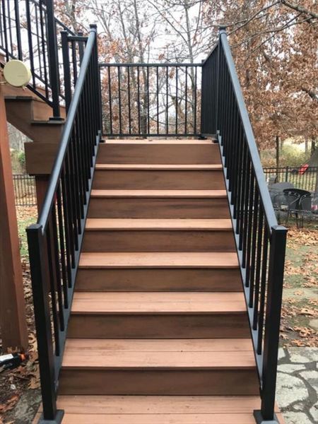 Composite deck in Warrensburg Missouri. The color of the deck is a bold tropical color called Tiki Torch.