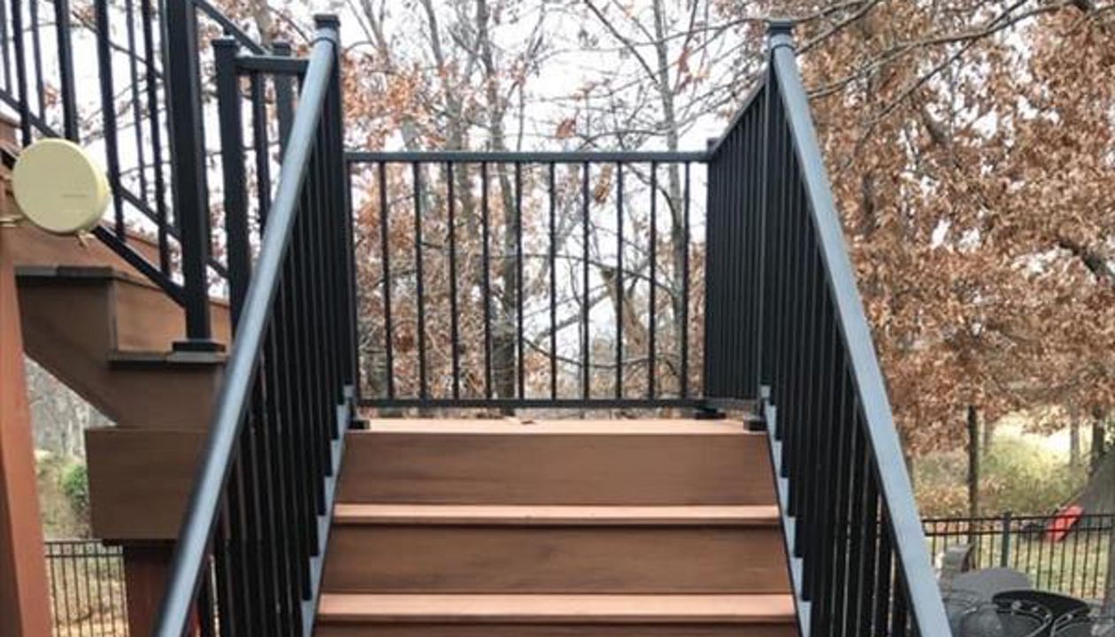 Composite deck in Warrensburg Missouri. The color of the deck is a bold tropical color called Tiki Torch.