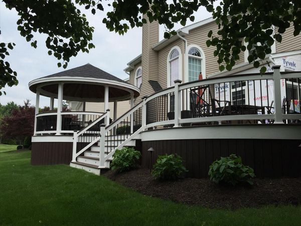 Classic white-railed deck with steps leading to a covered outdoor area.