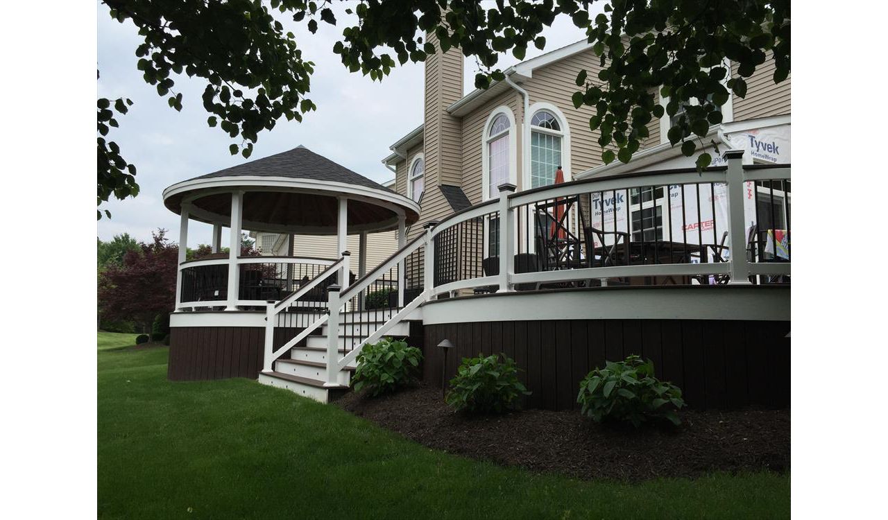 Classic white-railed deck with steps leading to a covered outdoor area.