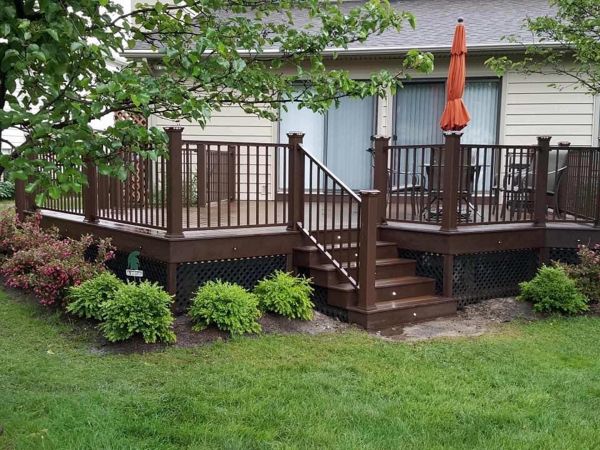 Spiced Rum decking with Vintage Lantern double border, and fascia. Signature bronze rail with Vintage Lantern posts and post cap lights. Keego Harbor, Michigan