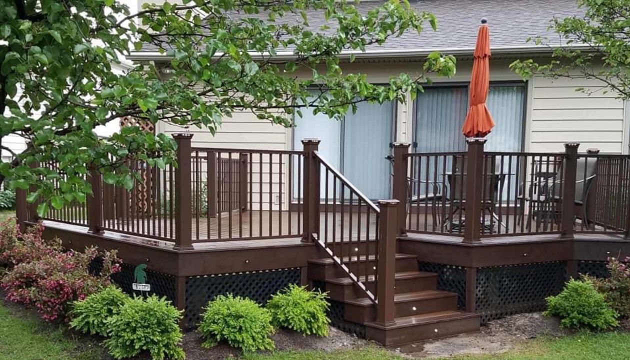 Spiced Rum decking with Vintage Lantern double border, and fascia. Signature bronze rail with Vintage Lantern posts and post cap lights. Keego Harbor, Michigan