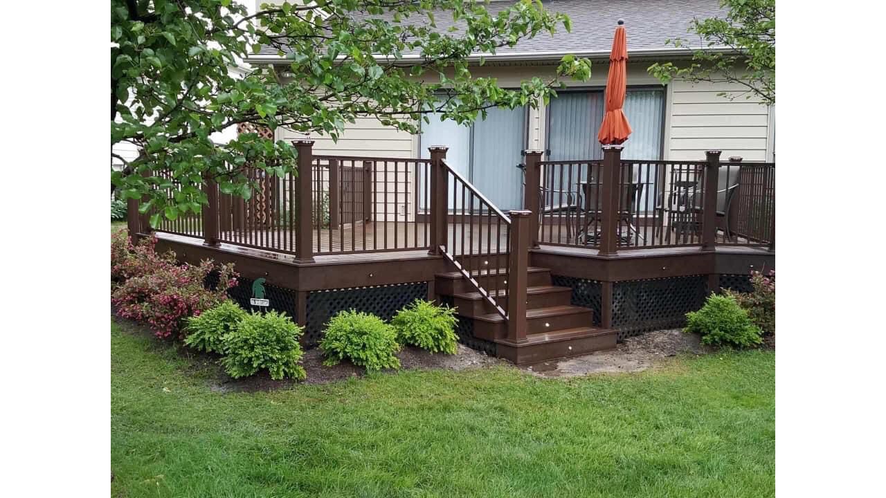 Spiced Rum decking with Vintage Lantern double border, and fascia. Signature bronze rail with Vintage Lantern posts and post cap lights. Keego Harbor, Michigan