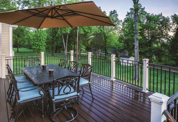 A Lava Rock Trex Transcend deck in Bridgewater, N.J., gets its deserved time in the limelight — courtesy of Trex Classic White posts with flat post cap lights and recessed floor flights.