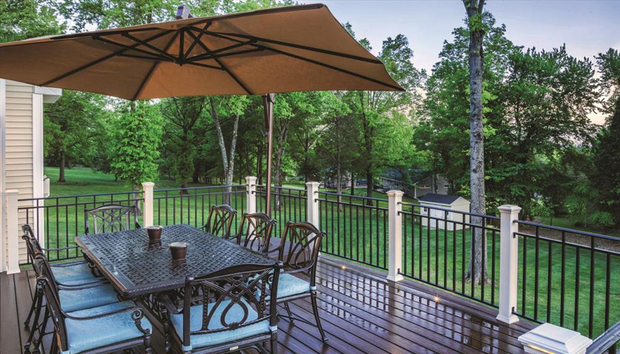 A Lava Rock Trex Transcend deck in Bridgewater, N.J., gets its deserved time in the limelight — courtesy of Trex Classic White posts with flat post cap lights and recessed floor flights.