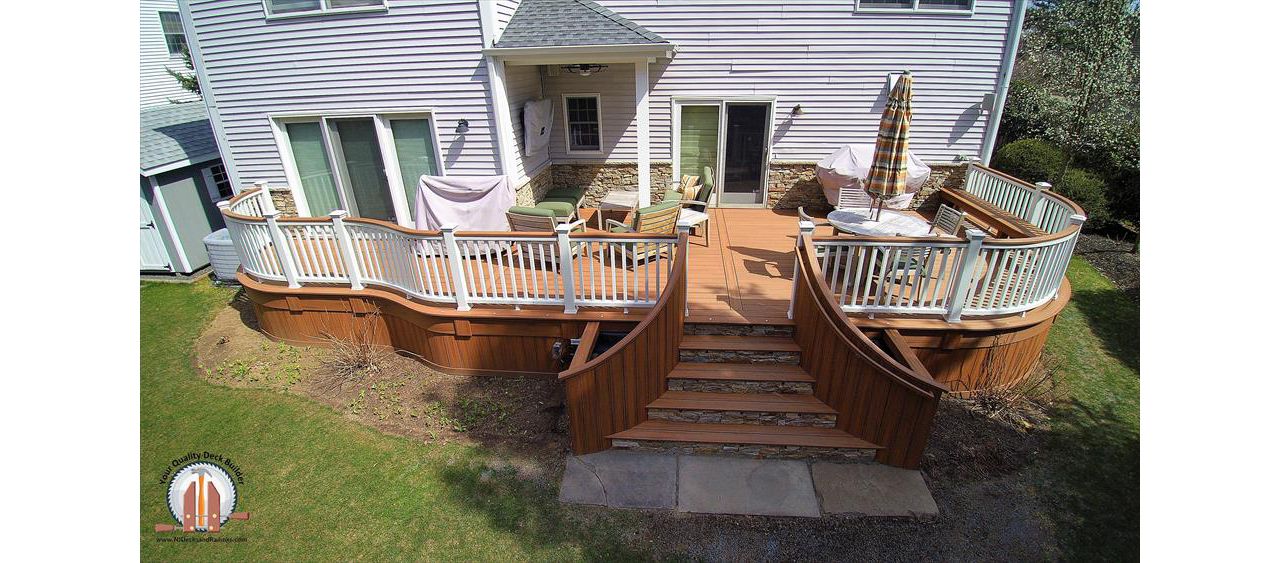 Custom curved Tiki Torch Decking with Tiki Torch Cocktail Rail and stone faced risers in HoHoKus, NJ