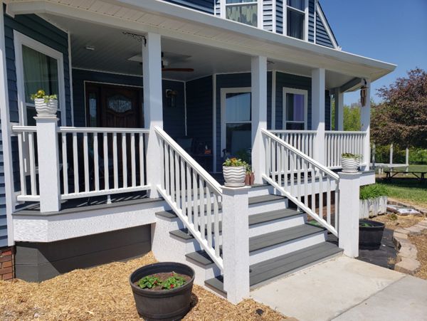 New front porch we built for this home using Trex decking, handrails and fascia - included adding a roof over the porch