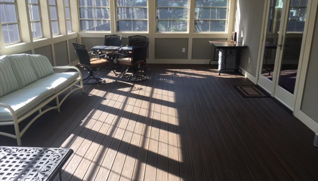 Trex Transcend Spiced Rum porch plank on 3 seaons room gives the look of a continuous tongue & groove hardwood flooring with the durability & low maintenance of Trex!