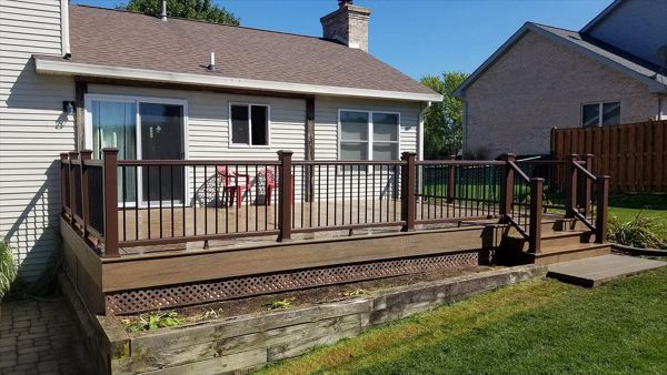 New deck in McHenry showcases Trex Enhance Naturals in Toasted Sand.  Transcend Railing in Vintage Lantern w/ black aluminum rods completes this deck.