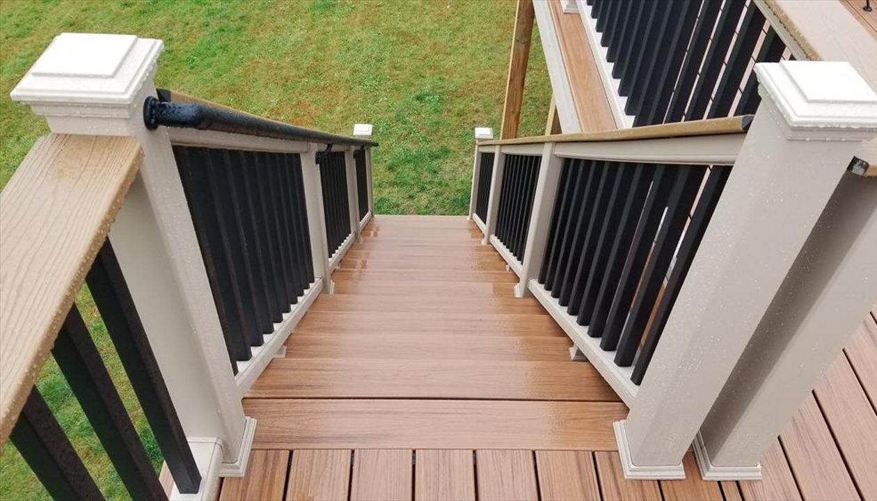 Trex Transcend Tropics Tiki Torch deck boards with Transcend railing (Rope Swing rails with Black balusters and Enhance Beach Dune Drink Rail), Rope Swing fascia serving the Twin Cites, Hastings, Woodbury, Egan, Edina, Minneapolis, Lake of the Isles
