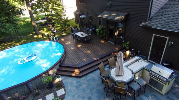 Ground level pool deck featuring Trex Transcend Spiced Rum decking with Trex Signature aluminum railing in black