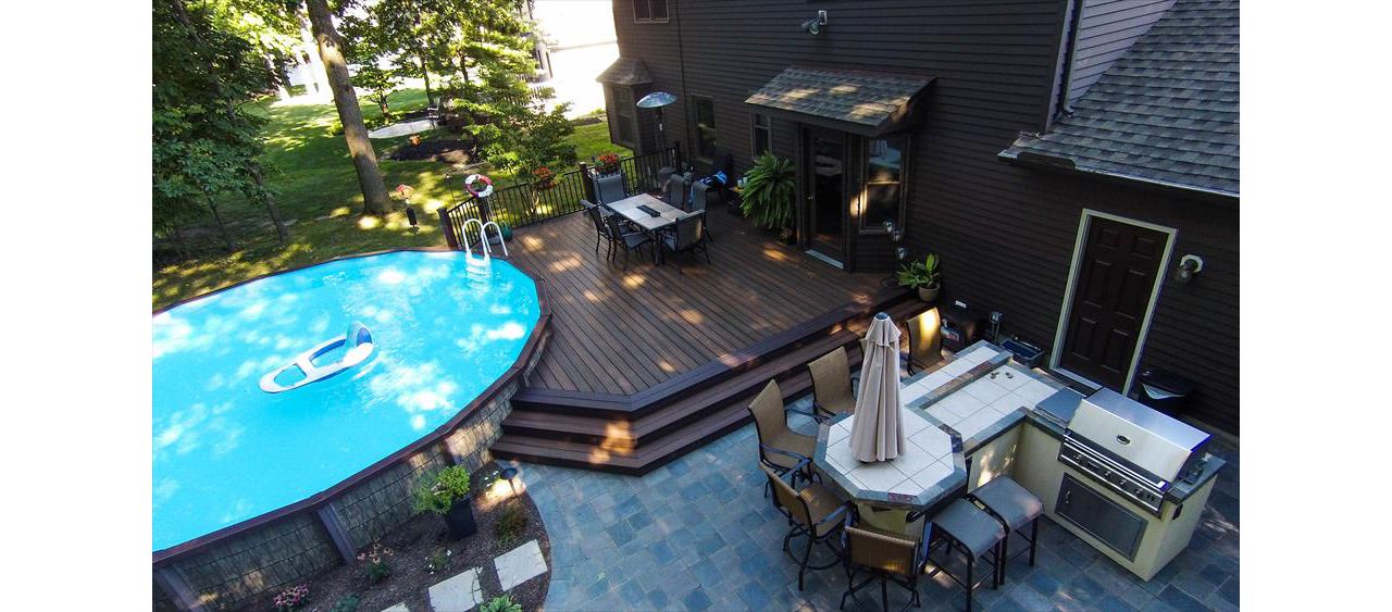 Ground level pool deck featuring Trex Transcend Spiced Rum decking with Trex Signature aluminum railing in black