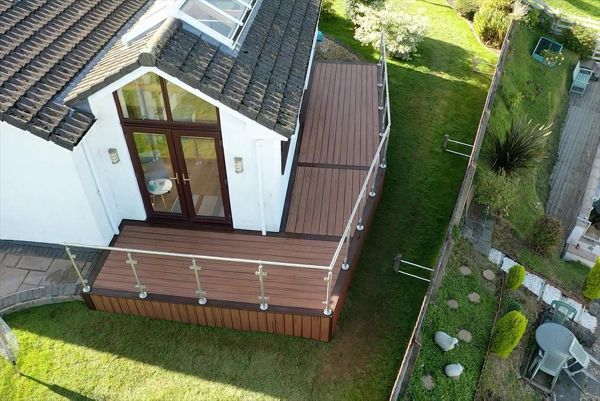 Trex Transcend Tiki Torch field with Larva Rock boarder with Stainless steel and glass railing fitted at Swansea