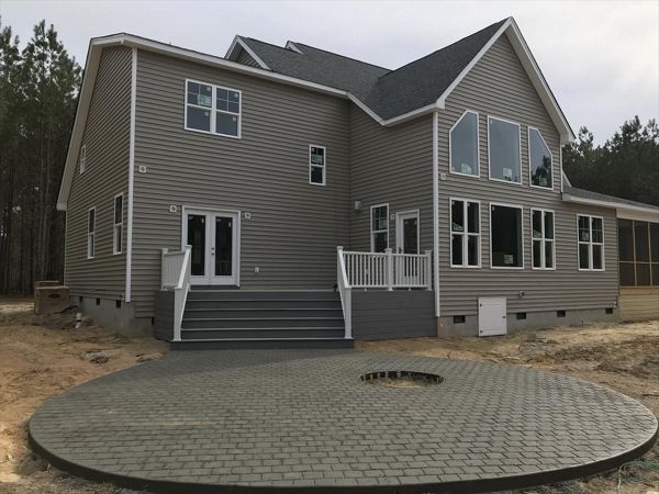 This Trex deck with massive set of steps leading to a fire pit patio is a great way to escape!
