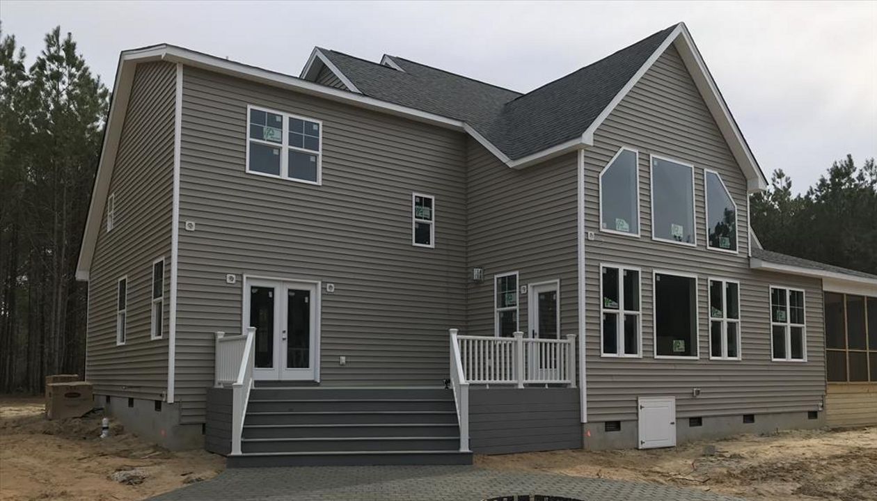 This Trex deck with massive set of steps leading to a fire pit patio is a great way to escape!