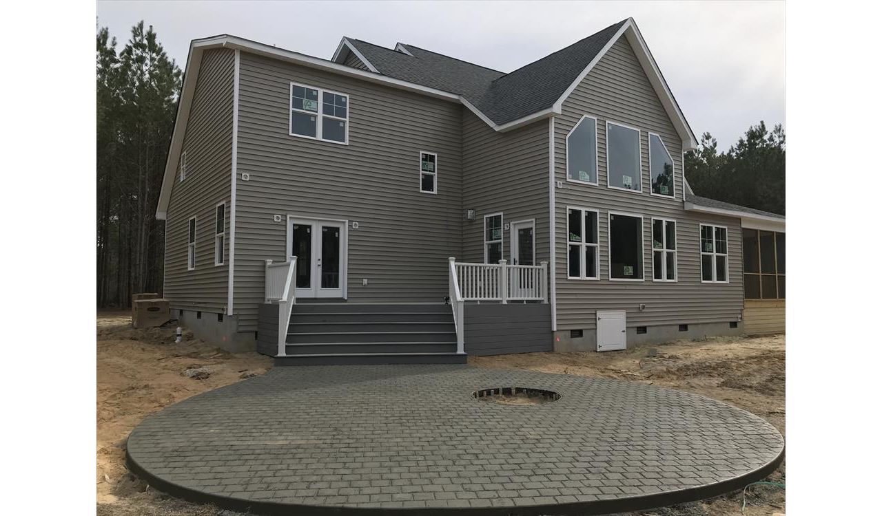 This Trex deck with massive set of steps leading to a fire pit patio is a great way to escape!