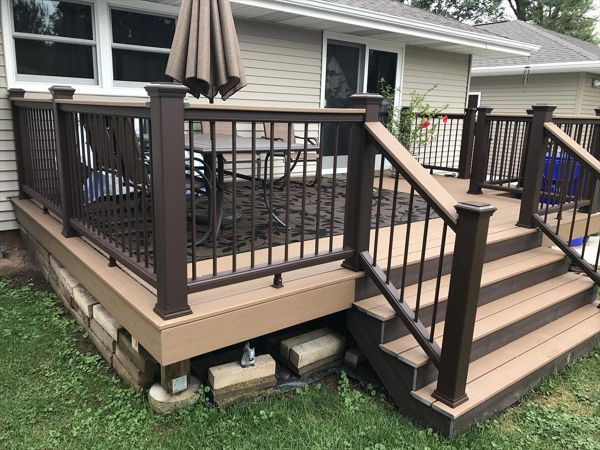Trex deck features vintage lantern and saddle color in Kaukauna by GE Contracting LLC