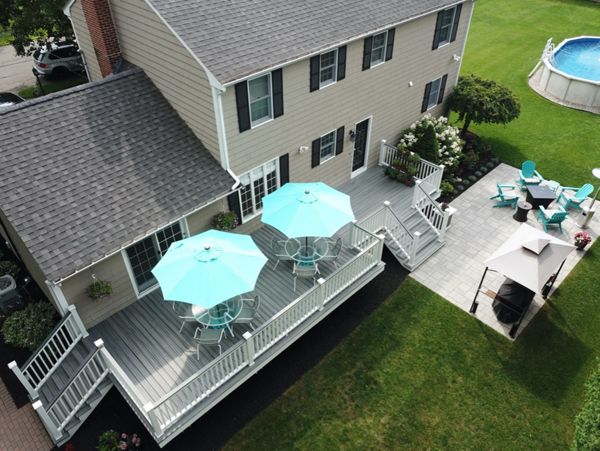Amazing 2-Tier 500 Square Foot Outdoor Living Deck Space, Trex Transcend Island Mist Decking with Trex Transcend White Composite Railings and Island Mist Cocktail Rails, in Peabody, MA