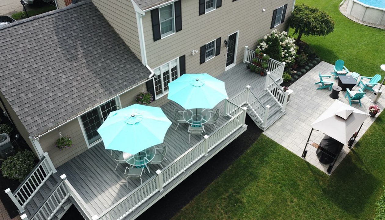 Amazing 2-Tier 500 Square Foot Outdoor Living Deck Space, Trex Transcend Island Mist Decking with Trex Transcend White Composite Railings and Island Mist Cocktail Rails, in Peabody, MA