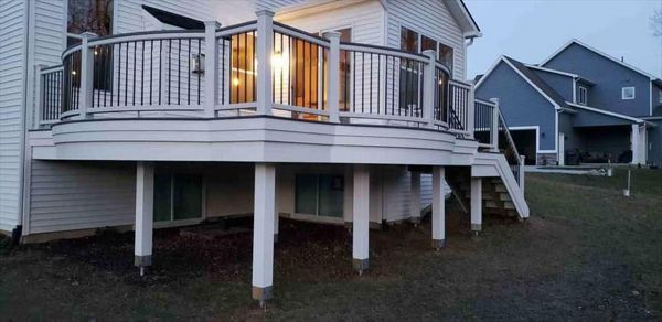 Trex Transcends island mist curved decking with white trex transcends curved rail. Goliath Tech helical piers. This beautiful deck is located in South Lyon, MI.