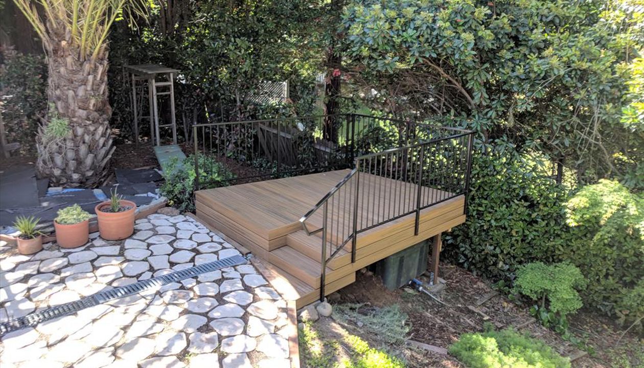 Custom Trex Havana Gold Deck in Redding, with hidden fasteners and custom railing in a backyard.  Majestic Builders is proud to provide top quality composite decks that will last a lifetime.