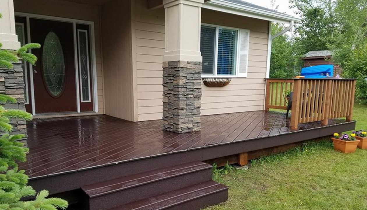 Trex Select Decking in woodland brown. Standard wood railings with Trex top cap. *note customer chose to center stairs with doorway and not the asphalt walkway.