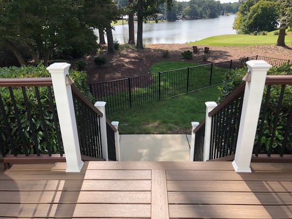 Image welcoming your friends & neighbors up on your new low maintenance Trex Enhnance deck with a view of the golf course & pond