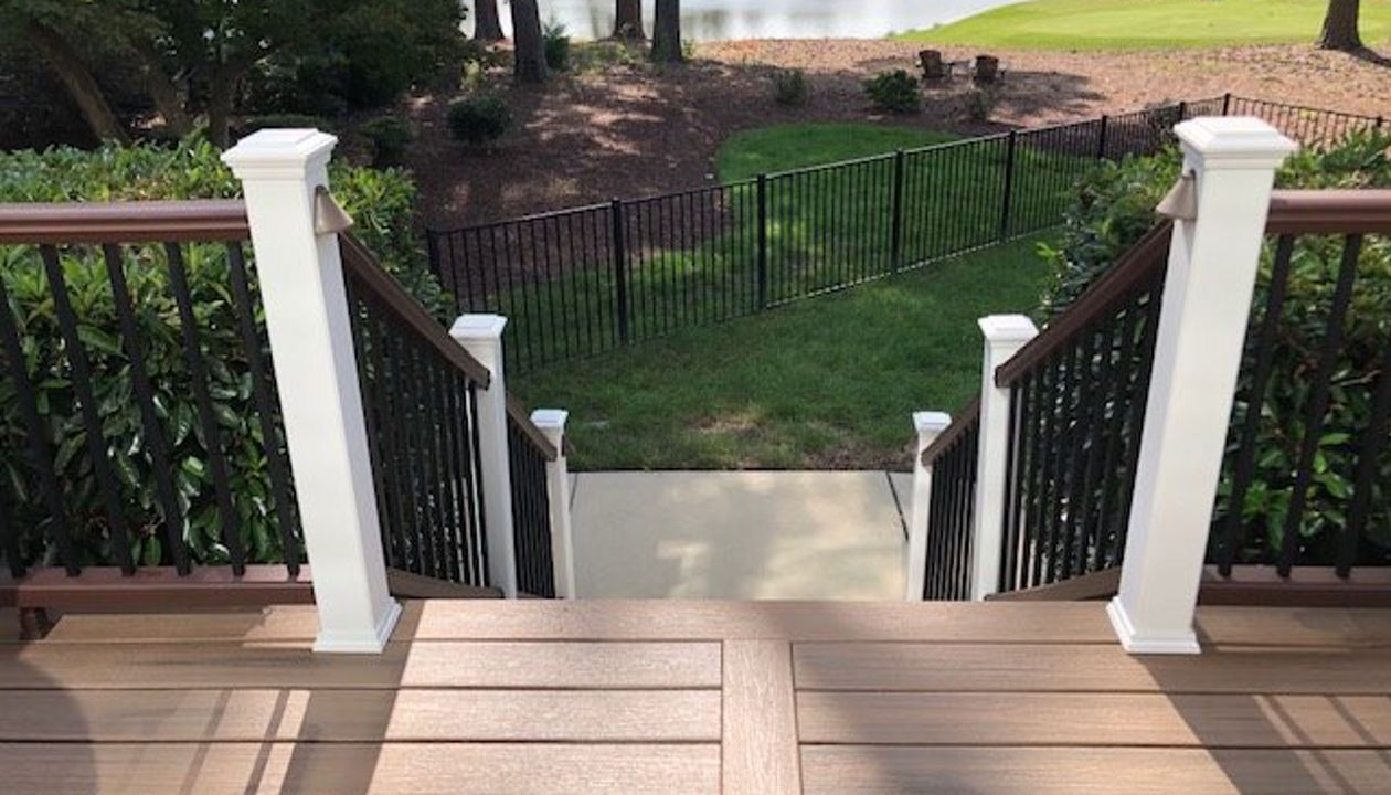 Image welcoming your friends & neighbors up on your new low maintenance Trex Enhnance deck with a view of the golf course & pond