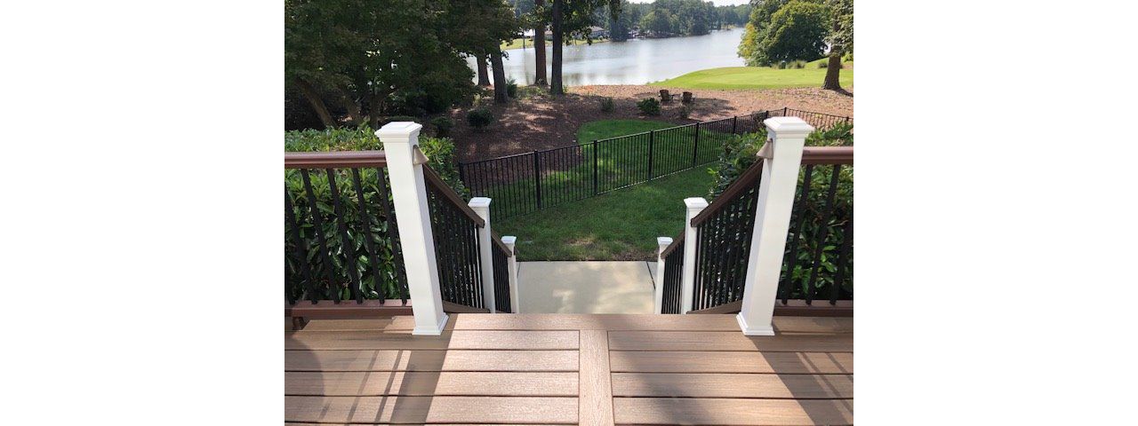 Image welcoming your friends & neighbors up on your new low maintenance Trex Enhnance deck with a view of the golf course & pond