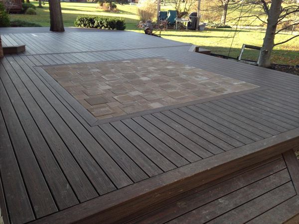 Check out this Trex deck Images Landscaping Image and Construction built in Northville, MI out of Trex Transcend Spiced Rum decking and fascia; featuring a brick paver inlay.
