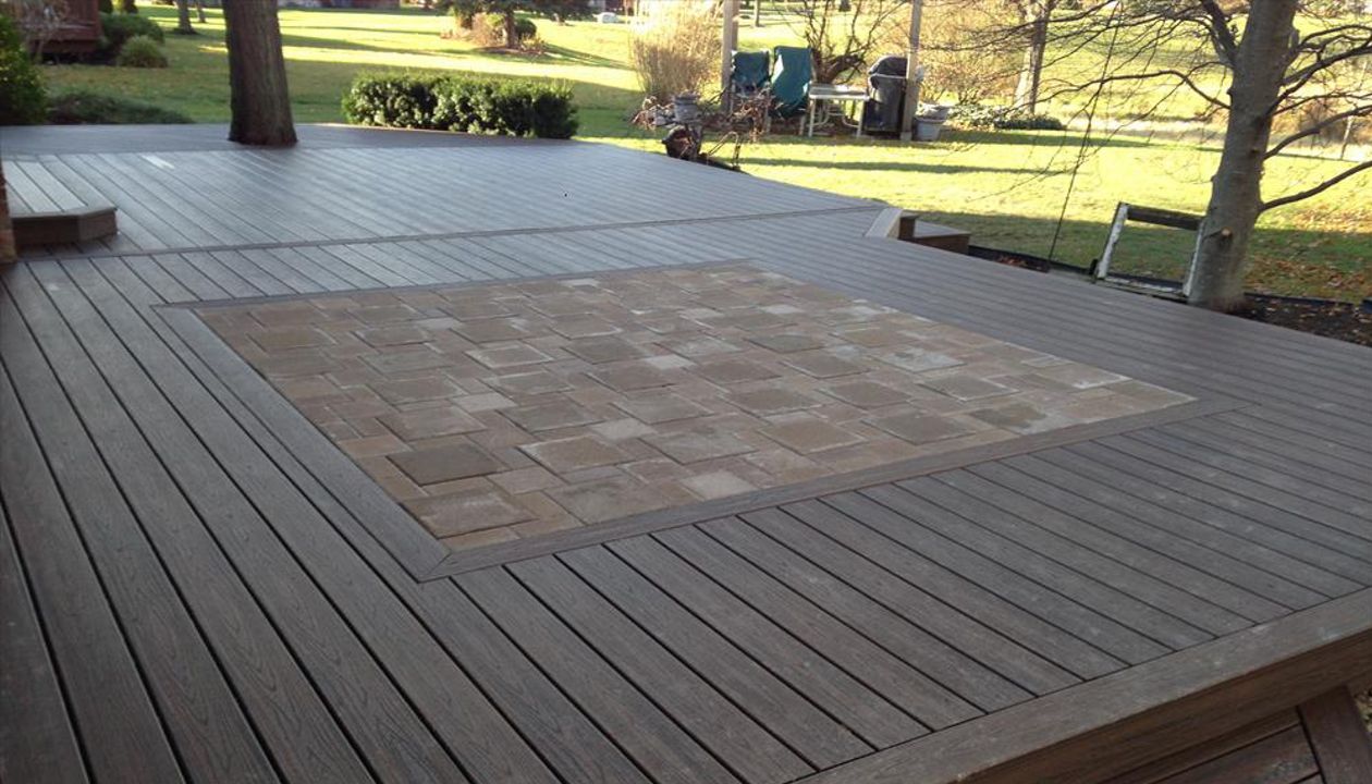 Check out this Trex deck Images Landscaping Image and Construction built in Northville, MI out of Trex Transcend Spiced Rum decking and fascia; featuring a brick paver inlay.