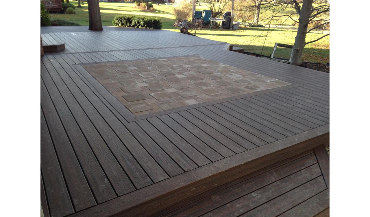 Check out this Trex deck Images Landscaping Image and Construction built in Northville, MI out of Trex Transcend Spiced Rum decking and fascia; featuring a brick paver inlay.