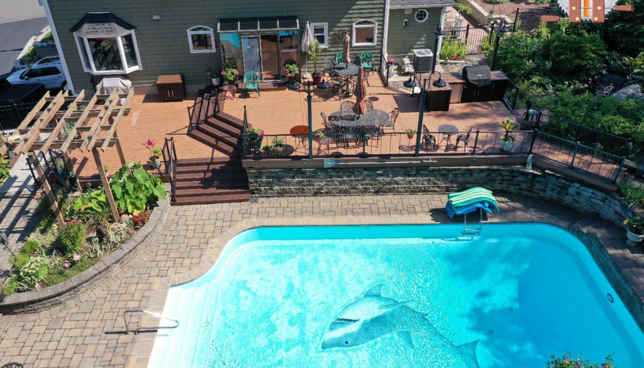 Trex Transcend Tiki Torch with Lava Rock border, Vertical cable railings and a builtin kitchen with custom concrete countertops.