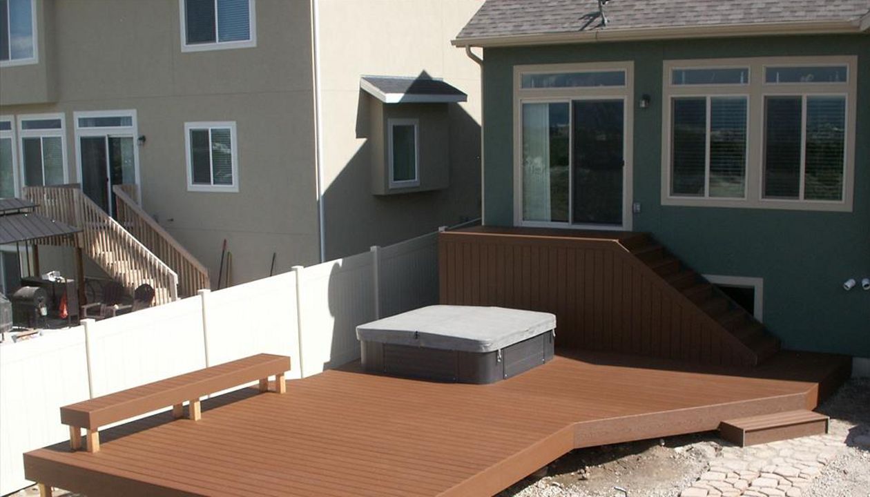 24x12 Trex saddle lower platform, skirted storage and built around hot tub with trex bench