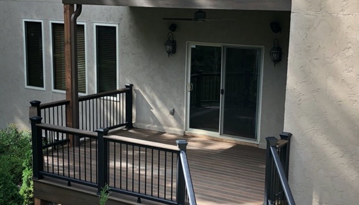 Trex/Transcend/Spiced Rum Composite Decking with Trex/Transcend Universal Composite Railing (black with round aluminum balusters) and Trex/Transcend Spiced Rum Composite Decking with Trex/Post Cap Accent Lighting and Trex Stair Accent Lighting