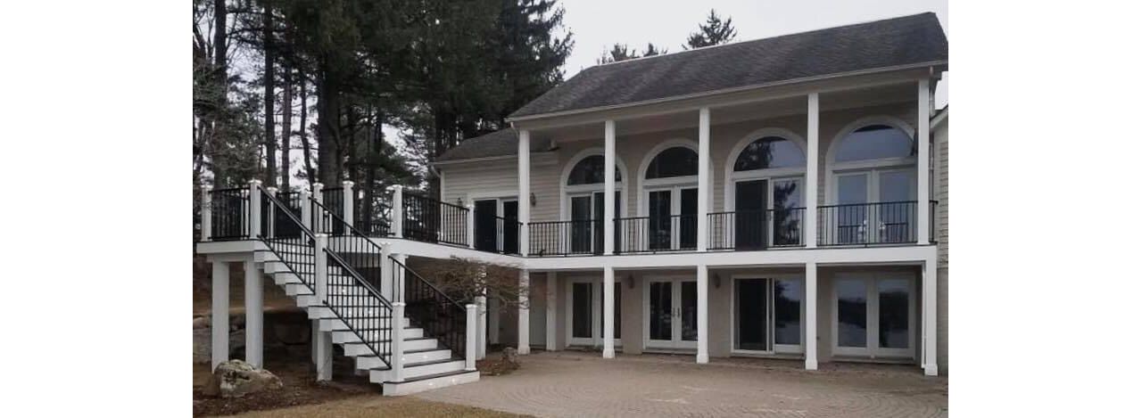Vintage Lantern decking and border. Post Cap lights White fascia. Signature black rail with white posts. Footings wrapped. Waterford, Michigan