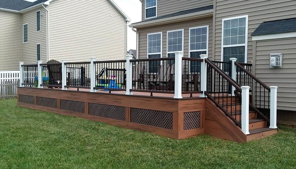 Tiki Torch decking with Vintage Lantern border, White post, vintage lantern rails w/ black pickets. Trex post and riser lighting.