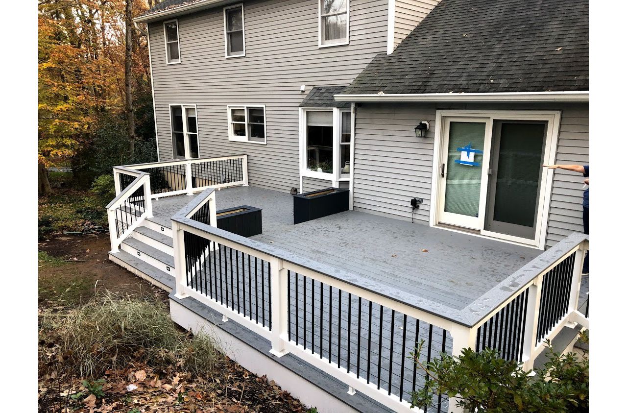 Trex Select Pebble Gray Composite Decking with White Vinyl Railing + Round Black Aluminum Balusters + matching Pebble Gray Cocktail Rail and two Composite Planters