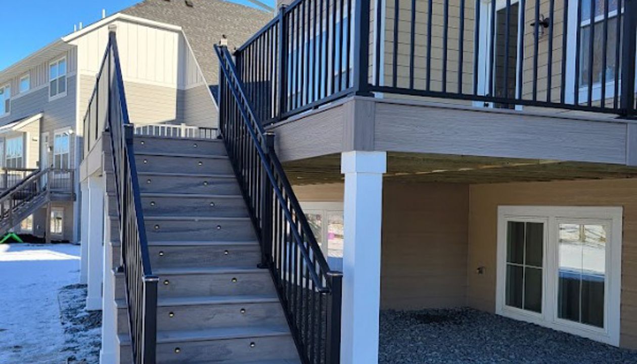 The new Trex Transcend Lineage decking using Biscayne, PVC post wraps, with post cap and stair tread lighting.