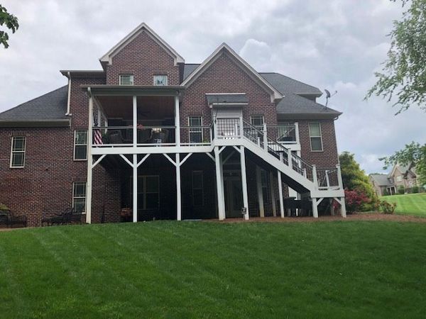 Incredible new Trex Select Pebble Grey decking & Select Classic white railing on deck & covered porch in Pfaftown, NC
