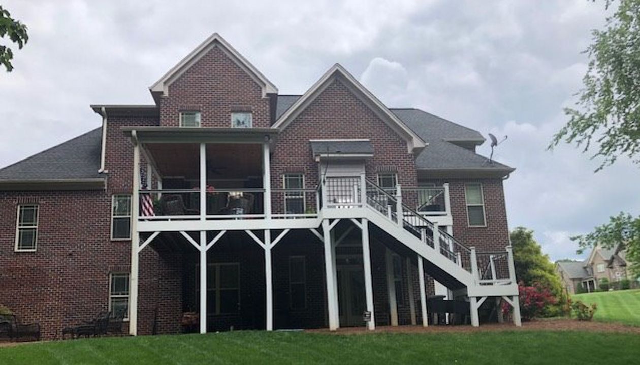 Incredible new Trex Select Pebble Grey decking & Select Classic white railing on deck & covered porch in Pfaftown, NC